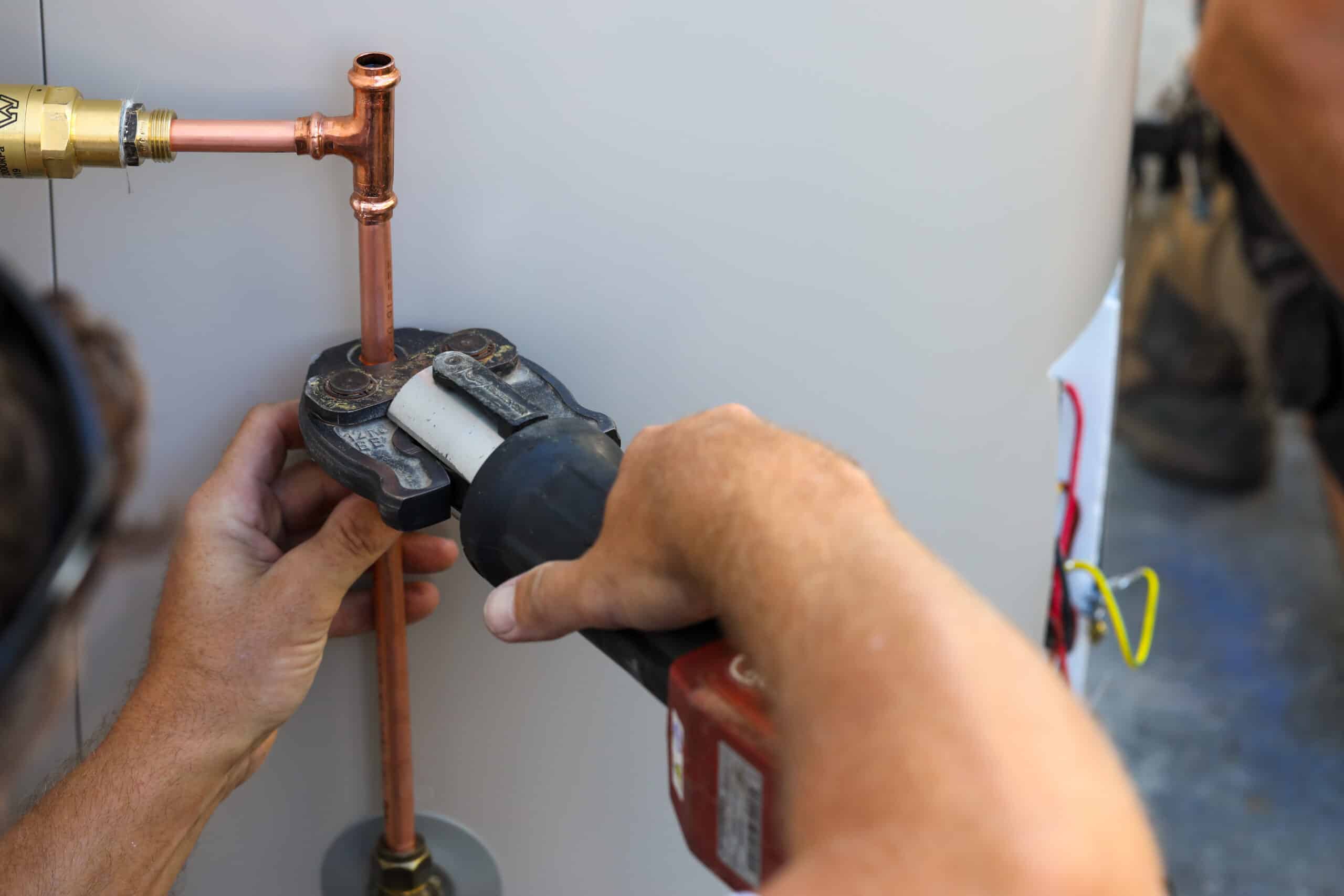 Image of a Plumber installing a hot water line